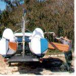 Larry Tibbe, below, scampers around Stiletto's hull as he casts off tic-downs before beginning the setting-up process. Note boat's narrow beam for trailering