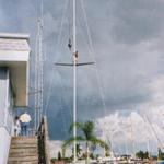 Mark, the owner, finally gets to unhook the mast from the crane. Note the 18' spreaders.